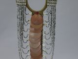 a sculpture of a woman with a chain around her neck