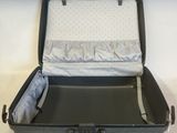 a black suitcase with a white lining inside of it