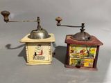 two old coffee grinders sitting next to each other on a table