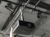 a video projector hanging from the ceiling in a building