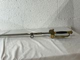 an old sword sitting on top of a white sheet next to a wall