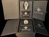 a box with a watch inside of it on a black surface