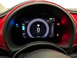 the dashboard of a red car with a digital display on it