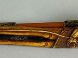 a wooden object that is laying down on a table