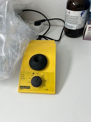 a bottle of alcohol sitting next to a blender on a counter