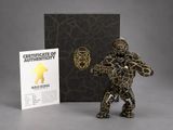the figurine is standing next to the certificate of authenticity