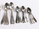 five spoons and two spoon spoons on a white surface