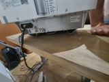 a person that is using a sewing machine on a table