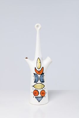 a white vase with a design on it on a table