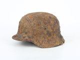 rusty helmet on a white surface with a white background
