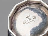a close up of a silver plate on a table