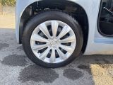 a close up of a car ' s tire with the door open