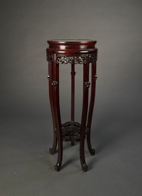 a round table with a wooden base and a glass top
