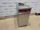 an image of a silver refrigerator sitting on top of a floor next to a wall