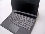 a laptop computer sitting on top of a white table