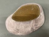 a picture of a rock with a brown stone in it