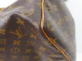 a close up of a louis vuitton bag on a white surface
