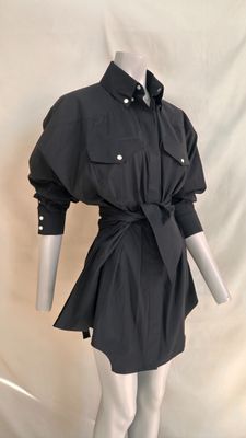 the mannequin is wearing a black shirt dress with a belt