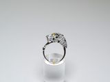 a close up of a ring with a diamond on top of a clear glass