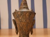an image of a bronze vase on a wooden table