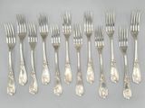 a lot of forks and spoons that are on the table