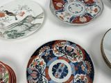 many plates with different designs on them on a table