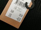 a label on the back of a sweater that is attached to a hanger