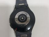 a close up of a black watch on a white surface
