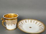 two cups and a saucer are sitting on a table