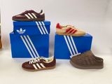three pairs of shoes sitting on top of a blue box