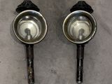 pair of stainless steel bowls with handles on a gray surface