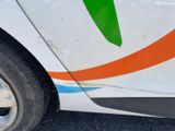 a close up of a white car with a green arrow painted on the side
