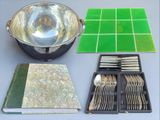 silverware and silverware on a table with green tiles