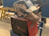 a welding machine with a helmet on top of it