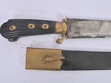 two knives that are laying side by side on a table