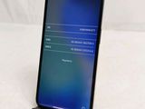 the back of a black iphone with a blue screen on a white surface