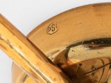 brass plate with a spoon and a spoon rest on top of it