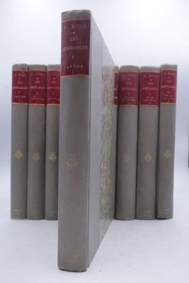 several books are lined up in a row on a white surface