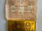 gold bar with a piece of paper on it sitting on a table