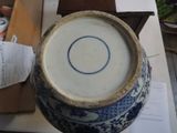 a large blue and white vase sitting on a table