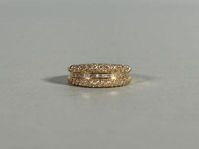 a close up of a pair of gold rings on a white surface