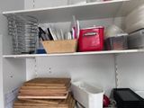 a shelf full of dishes and utensils in a kitchen