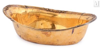 a gold bowl that is sitting on a white surface