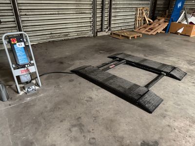 an image of a garage with a cart and a ladder