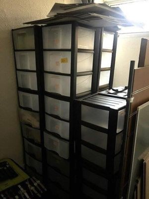 a stack of plastic containers sitting on top of a shelf