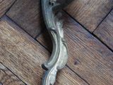 a close up of a metal object on a wooden floor