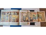 an open book with pictures of people on it sitting on the floor