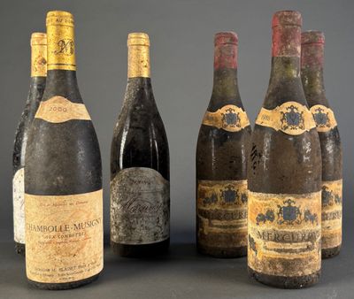 several bottles of wine are lined up on a table
