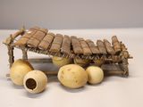 a small wooden structure with a bunch of bananas on top of it
