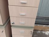 several drawers are stacked on top of each other in front of a door